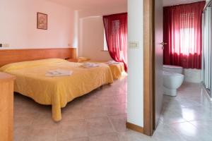 Ένα ή περισσότερα κρεβάτια σε δωμάτιο στο HOTEL BRUNFORTE