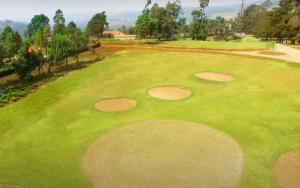 an overhead view of a golf course with a green at The Fortuna Hotel and Cafe in Kabale
