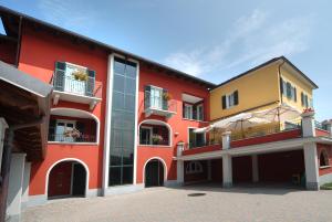 a red building with windows and balconies at Hotel Ristorante del Peso in San Michele Mondovì