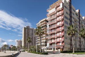 a rendering of a tall apartment building with palm trees at El Raco, C-9-17 in Cullera