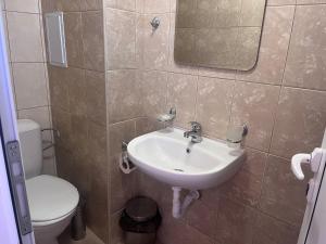 a bathroom with a sink and a toilet at Guest House Kolev 2 in Sunny Beach