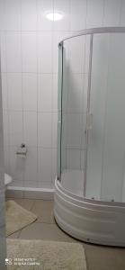 a shower with a glass door in a bathroom at Берізка in Voznesensk