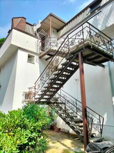 a spiral staircase on the side of a building at Sea Side Attic in Rosolina Mare