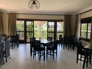 a dining room with a table and chairs at The Fortuna Hotel and Cafe in Kabale