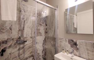 a bathroom with a shower and a sink at Hotel Cecina Beach in Marina di Cecina