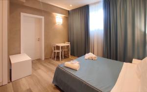 Postel nebo postele na pokoji v ubytování Hotel Cecina Beach