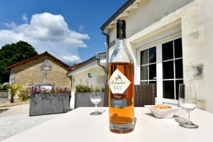 a bottle of wine sitting on a table with two glasses at domaine d' Arcalis in Archiac