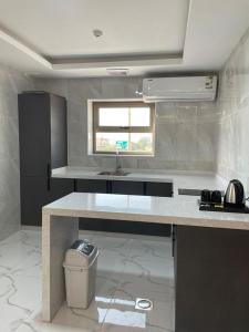 a kitchen with a sink and a toilet in it at أبراج الجزيرة in Al Hofuf