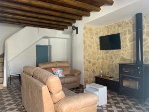 a living room with a couch and a fireplace at Casa Genilla in Priego de Córdoba