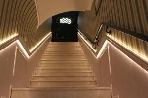 a staircase leading up to a building with a clock on the wall at Hotel 1883 in Baku