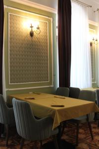 a dining room with a table and chairs and a window at Hotel 1883 in Baku