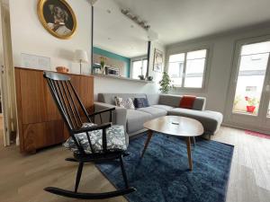 a living room with a couch and a chair at Spacious 1 bedroom apartment near Paris in Garches