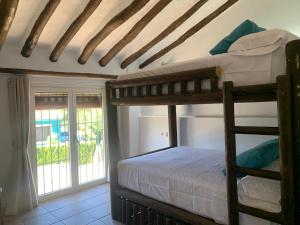 a bedroom with two bunk beds and a balcony at Casa Genilla in Priego de Córdoba +36 photos