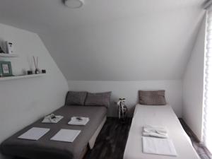 a small room with a bed and a couch at Villa Hani in Sarajevo