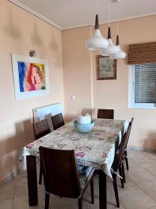 a dining room with a table and chairs at Amazing view Panorama Eretrias in Eretria