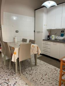 a kitchen with a table and chairs in a room at Casa Aurora in Catania