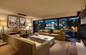 a living room with a couch and a table at Park Hyatt Sydney in Sydney