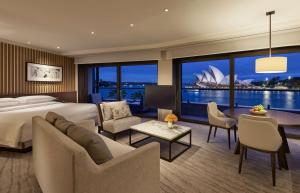 a hotel room with a bed and a view of the sydney opera house at Park Hyatt Sydney in Sydney
