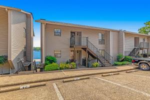 a row of houses with a car parked in a parking lot at Lake Escape in Hot Springs