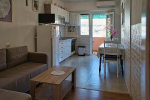 a living room with a couch and a table at Apartment Ella in Trogir