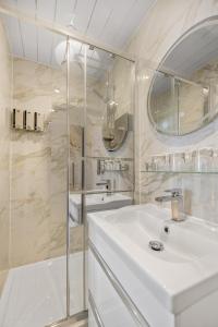 a white bathroom with a sink and a shower at The Drake Hotel Plymouth in Plymouth