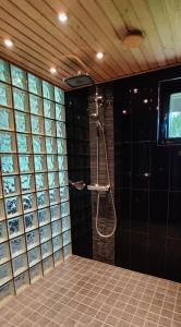 a shower in a bathroom with a wall of glass at Room by Lake 10 minutes from Tampere centrum in Lempäälä