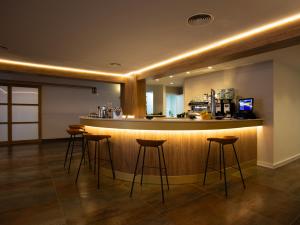 a bar in a room with stools in front of it at Hotel Montepiedra 4''''sup in Playas de Orihuela
