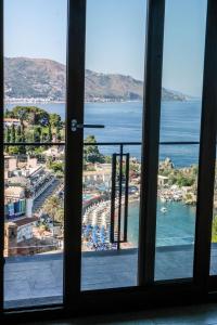a view of a beach from a window at Isola Bella Luxury View in Taormina