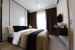 a bedroom with a large bed and a large window at Super Luxury Condo in Bangkok
