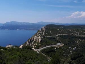 an aerial view of a mountain with water and a road at Blue Note Home, Cosy, Port Vieux in La Ciotat