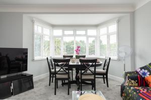 a dining room with a table and chairs at Solent Court in Portsmouth +4 photos