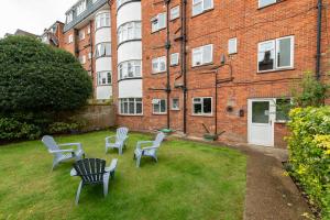 a yard with chairs and a table in front of a building at Solent Court in Portsmouth