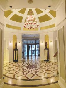 a large lobby with a chandelier and a large floor at Taj Cape Town - private luxury 5 star suites - very spacious with kitchenette in Cape Town