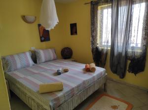 a bedroom with a bed with two stuffed animals on it at Casa Laranja Santa Maria in Santa Maria