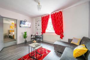 a living room with a couch and red curtains at *F6GH For your most relaxed & cosy stay + FREE PARKING & WiFi in Bramley