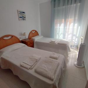 Ένα ή περισσότερα κρεβάτια σε δωμάτιο στο Piso 3 habitaciones en Pescadores, 6