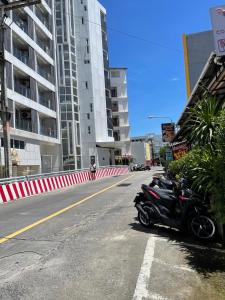 a row of motorcycles parked on the side of a street at Elephant Room in Patong Beach