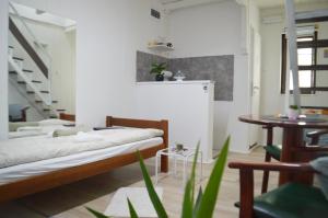 a living room with two beds and a table at Centar apartment in Gornji Milanovac