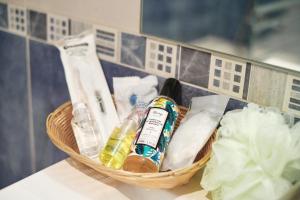 a basket of toiletries on a counter in a bathroom at Hotel Don Manuel in Gijón