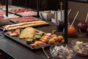 a buffet with a tray of food on a table at Martinshof berg herz hotel in San Giovanni in Val Aurina