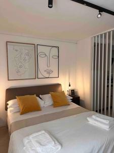 a bedroom with a bed with two pillows on it at David Design Apartment centro storico in Caorle