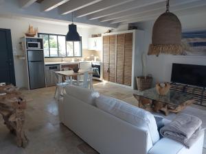 a living room with a white couch and a table at LOCATIONS NOS ILES in Saint-Jean-de-Monts