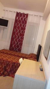 1 dormitorio con cama, mesa y escritorio en HOTEL BISSI, en Milán
