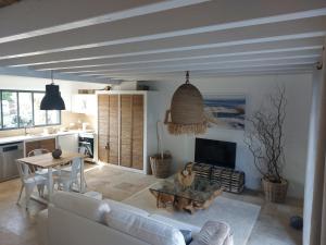 a living room with a couch and a table at LOCATIONS NOS ILES in Saint-Jean-de-Monts