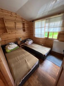 a small room with two beds and a window at Gród Piasta in Gąsawa +67 photos