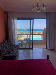 a living room with a couch and a view of the ocean at Navy Chalet 108 in Hurghada