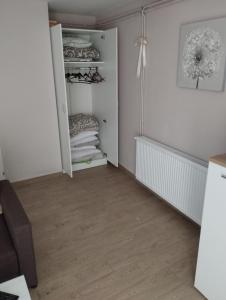 a room with a closet with white walls and wooden floors at Villa Klaudija in Petrovaradin +41 photos