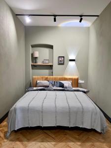 a bedroom with a large bed and a mirror at Art Apartment Glebova in Lviv