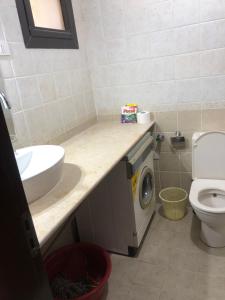 a bathroom with a sink and a washing machine at Navy Chalet 108 in Hurghada