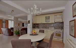 a kitchen with a white table and chairs at Vila Djordjevic in Herceg-Novi